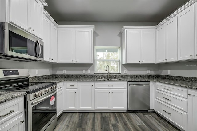 kitchen featuring sink, white cabinets, stainless steel appliances, and dark hardwood / wood-style floors