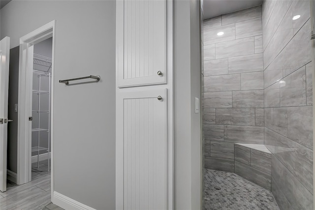 bathroom with a tile shower