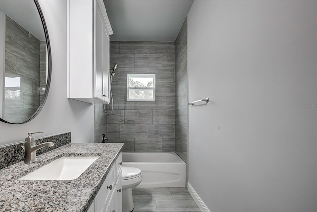 full bathroom with vanity, toilet, and tiled shower / bath combo