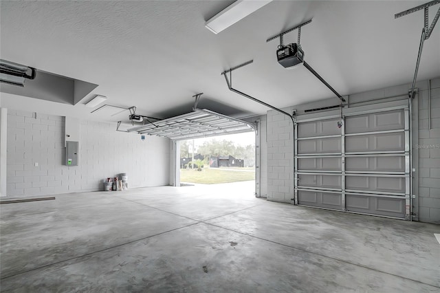 garage with electric panel and a garage door opener