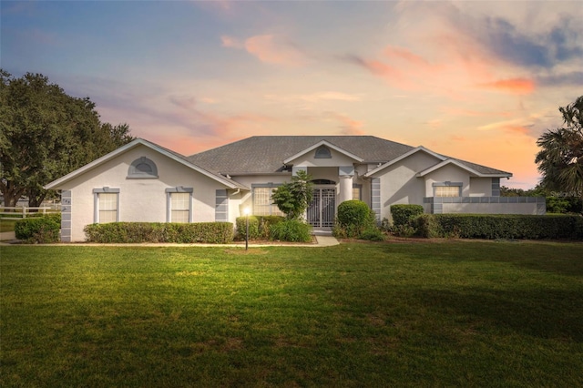 ranch-style home featuring a lawn