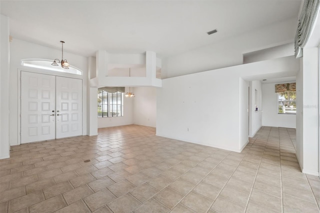 foyer entrance with a wealth of natural light and a chandelier