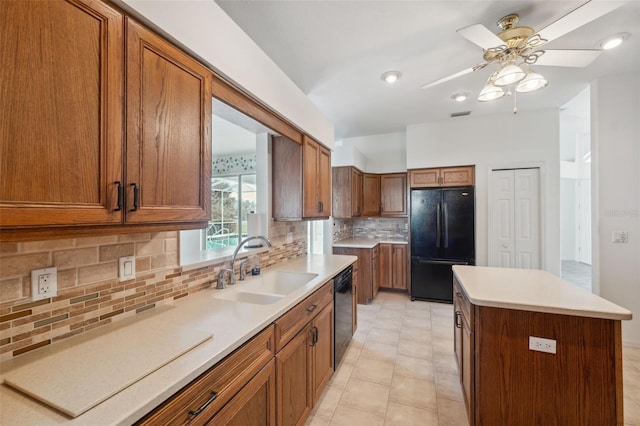 kitchen with black appliances, a kitchen island, sink, decorative backsplash, and ceiling fan