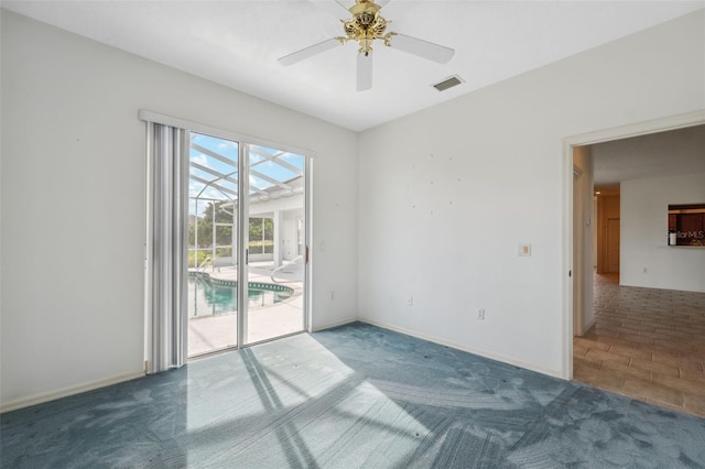 carpeted spare room with ceiling fan