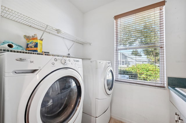 washroom with a healthy amount of sunlight and independent washer and dryer