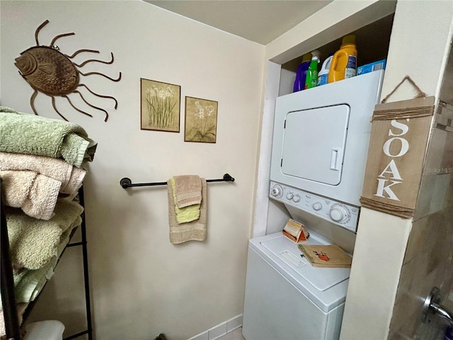 clothes washing area with stacked washer and dryer