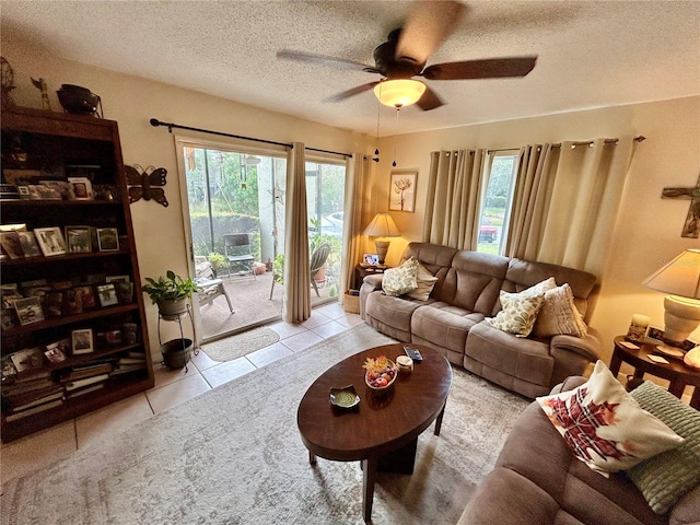 tiled living room with a textured ceiling and ceiling fan