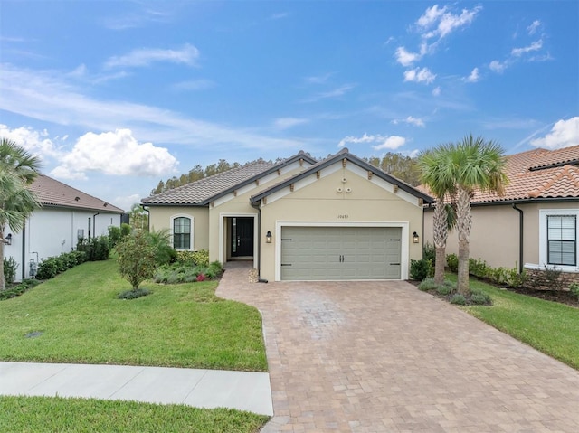 view of front of home with a garage and a front lawn