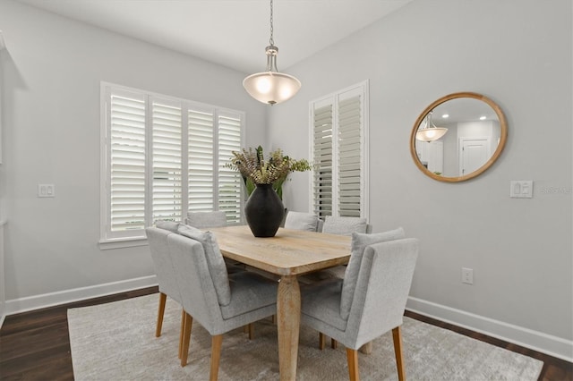 dining space featuring plenty of natural light and dark hardwood / wood-style flooring