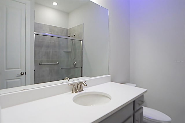 bathroom featuring walk in shower, vanity, and toilet