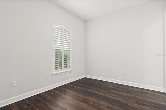 unfurnished room with dark hardwood / wood-style floors