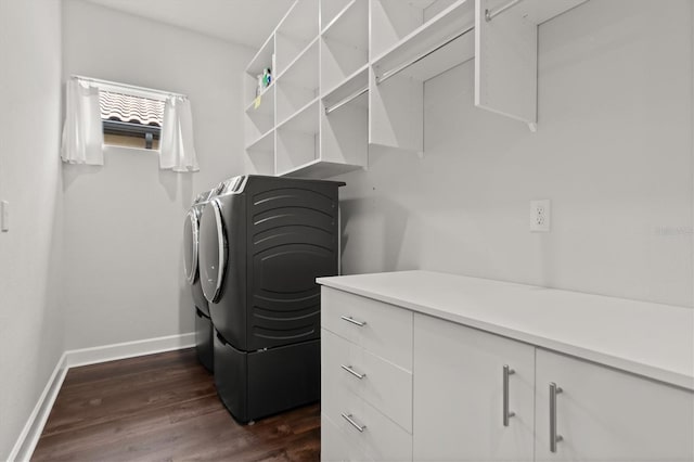 washroom with dark wood-type flooring, cabinets, and independent washer and dryer