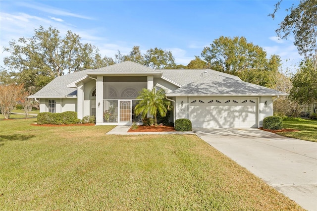 view of front of home featuring a front yard and a garage