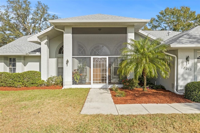 property entrance featuring a lawn