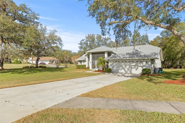 view of front facade with a garage and a front lawn