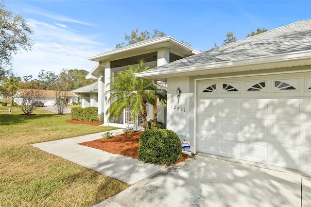 view of front of home with a front yard and a garage