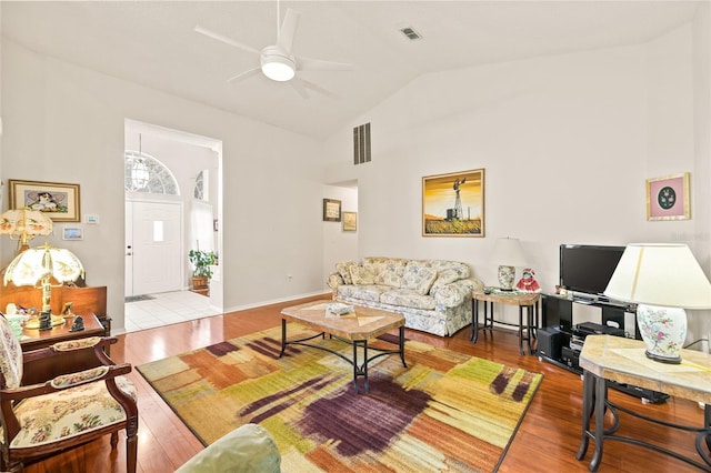 living room featuring light wood-type flooring, vaulted ceiling, and ceiling fan