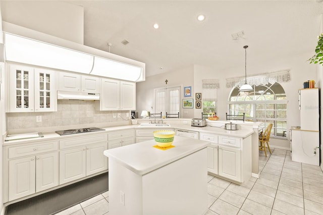 kitchen with kitchen peninsula, decorative light fixtures, white cabinets, a center island, and stainless steel gas stovetop