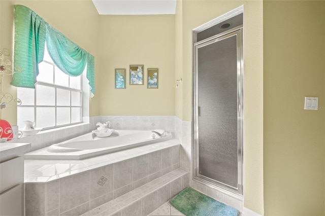 bathroom featuring vanity and independent shower and bath