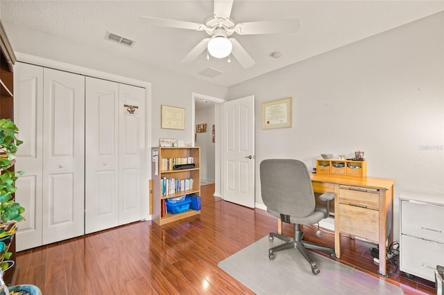 office featuring wood-type flooring, a textured ceiling, and ceiling fan