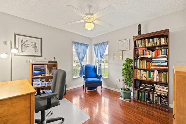 office area with a textured ceiling, dark hardwood / wood-style flooring, and ceiling fan