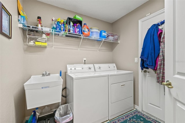 laundry room featuring washing machine and dryer and sink