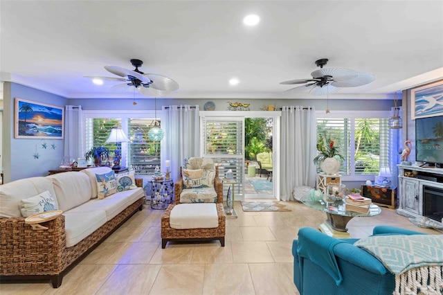 tiled living room with ceiling fan and a healthy amount of sunlight