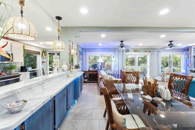 kitchen with decorative light fixtures and a healthy amount of sunlight