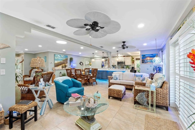 tiled living room featuring ceiling fan