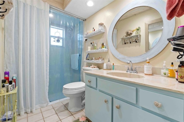 bathroom with vanity, walk in shower, tile patterned floors, and toilet