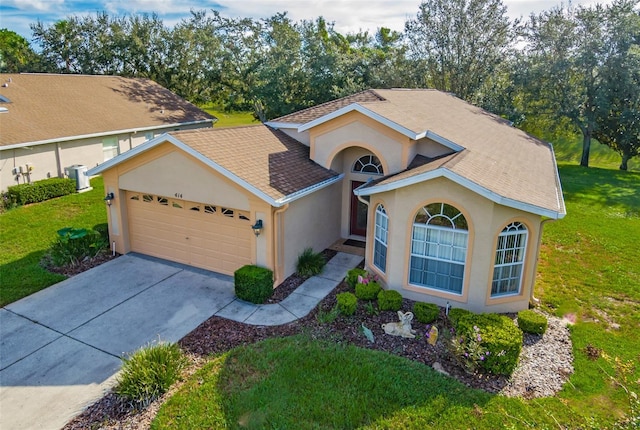 view of front of property with a front lawn and a garage