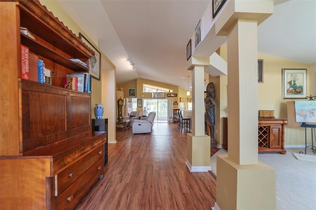 hall featuring lofted ceiling and hardwood / wood-style flooring