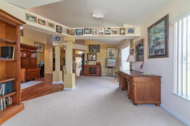 office space with light colored carpet and lofted ceiling