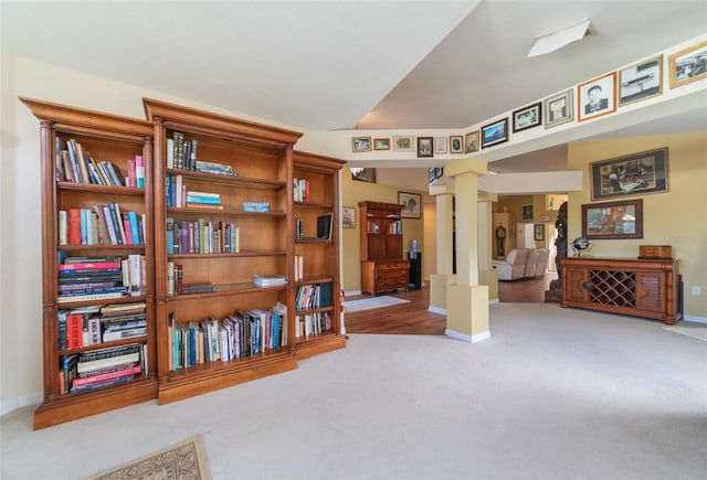 sitting room with ornate columns and carpet flooring