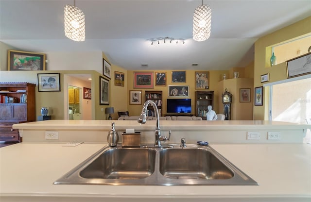 kitchen with sink, pendant lighting, and lofted ceiling