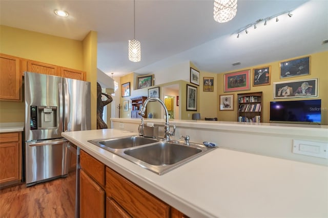 kitchen with stainless steel appliances, dark hardwood / wood-style floors, sink, and pendant lighting