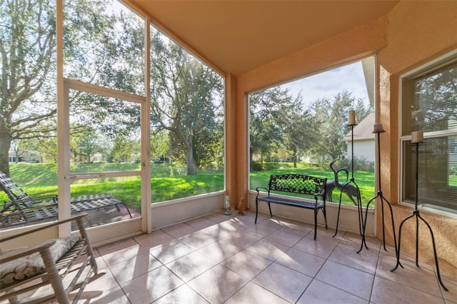 sunroom with plenty of natural light and vaulted ceiling