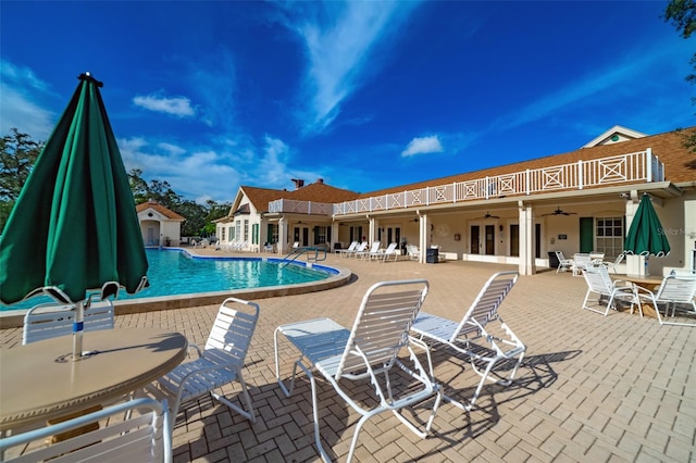 view of pool with a patio, french doors, and ceiling fan