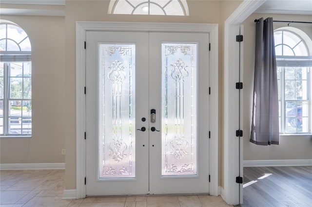 entryway featuring french doors and light hardwood / wood-style flooring