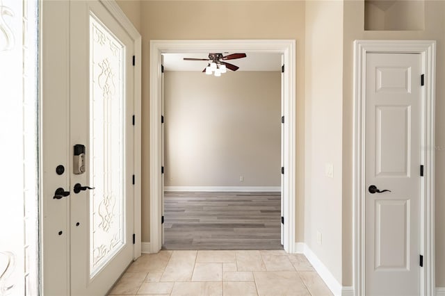 tiled foyer featuring ceiling fan