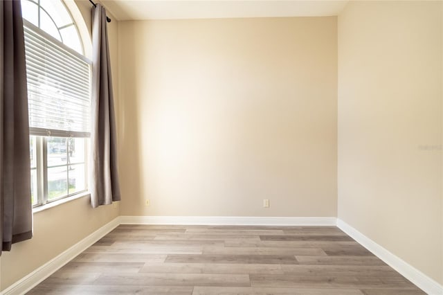 unfurnished room with light wood-type flooring