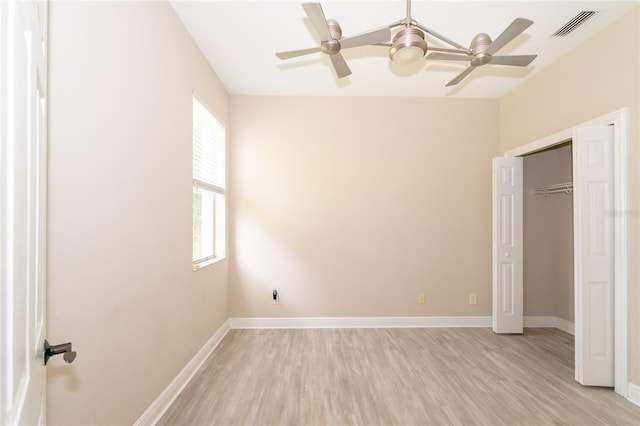 unfurnished bedroom with multiple windows, a closet, ceiling fan, and light wood-type flooring