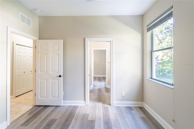 unfurnished bedroom featuring a closet and light hardwood / wood-style flooring