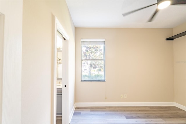 unfurnished room featuring ceiling fan and light wood-type flooring