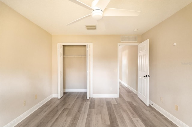 unfurnished bedroom with ceiling fan, light hardwood / wood-style floors, and a closet