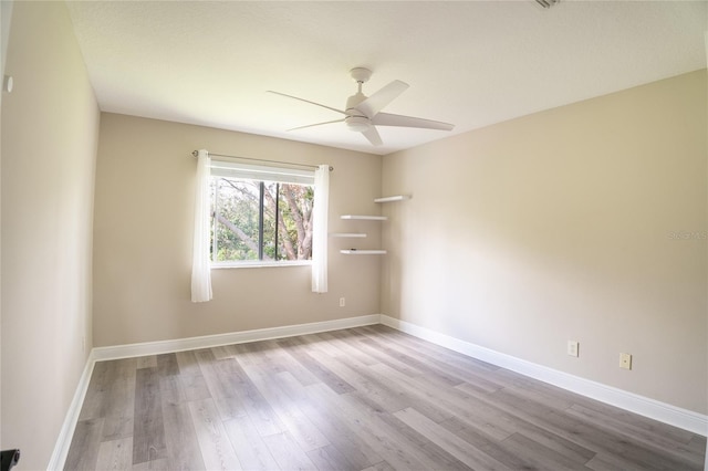 empty room featuring ceiling fan and light wood-type flooring