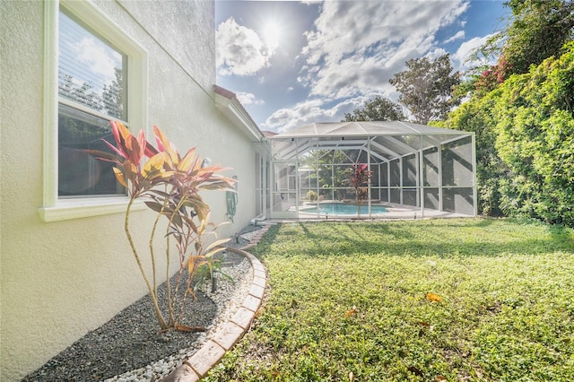 view of yard with glass enclosure