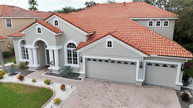 mediterranean / spanish home featuring a garage