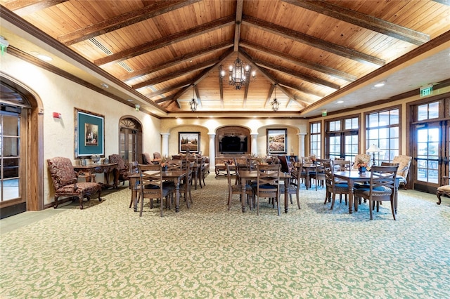 carpeted dining room with wood ceiling, beam ceiling, a chandelier, and high vaulted ceiling