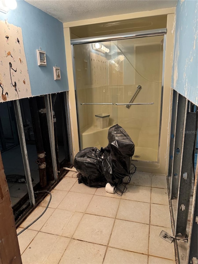 bathroom featuring a textured ceiling and tile patterned floors